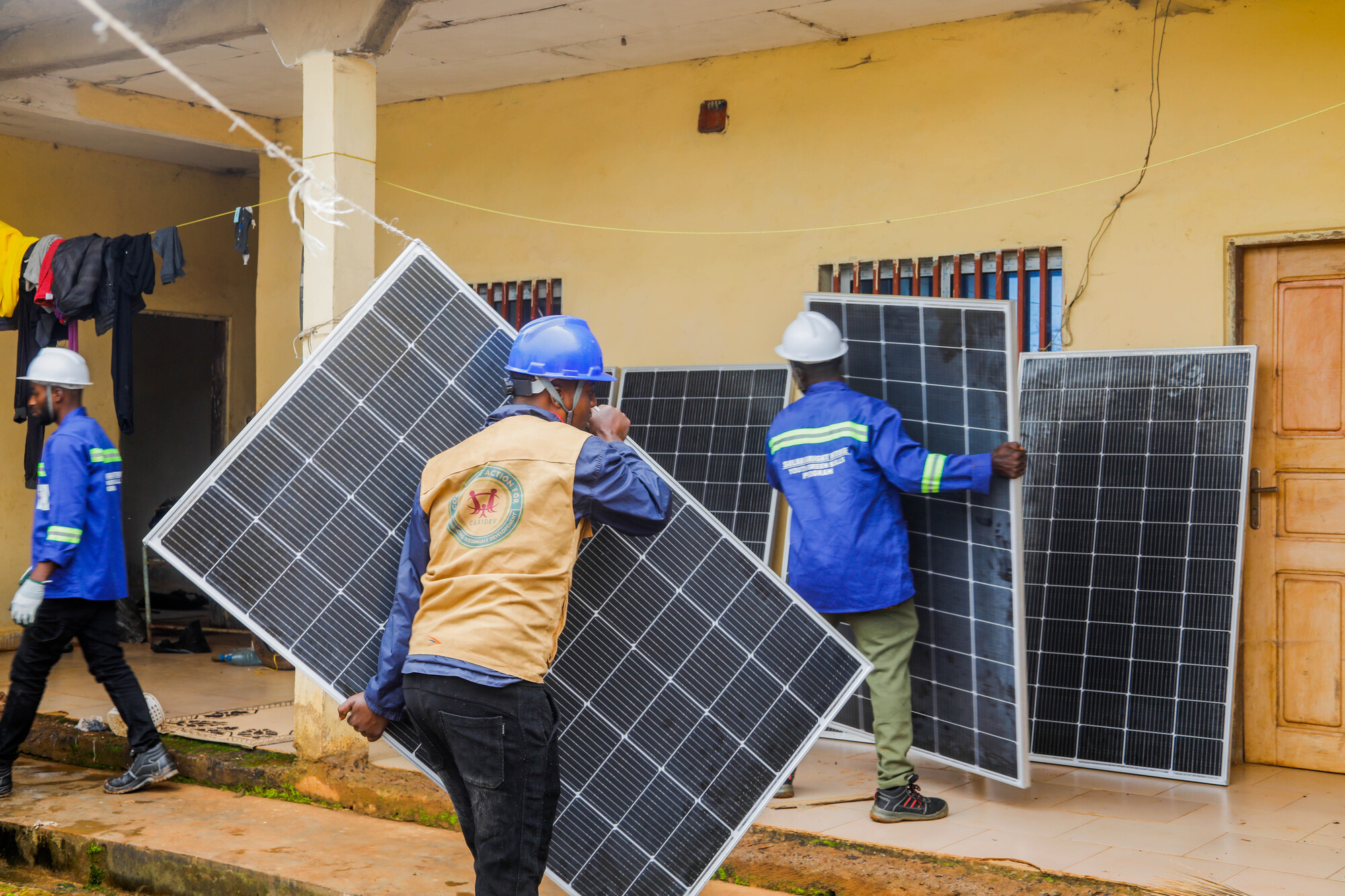 Image courtesy of the United Nations Sustainable Development Goals Action Campaign, an initiative of the UNDP. Internally displaced persons installing solar panels at a health center in northwestern Cameroon as part of the "Solar Bright Future" program. Image courtesy of the United Nations Sustainable Development Goals Action Campaign, an initiative of the UNDP.