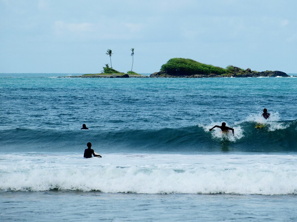 "Surfers Surfing at Busua Beach in Western region, Ghana.jpg" by Michal Vogt, CC BY-SA 2.0, via Wikimedia Commons Surfers Surfing at Busua Beach in Western region, Ghana.jpg — "Surfers Surfing at Busua Beach in Western region, Ghana.jpg" by Michal Vogt, CC BY-SA 2.0, via Wikimedia Commons
