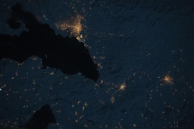 The city lights of Erciş, Türkiye, and its suburbs and villages, surround Lake Van
