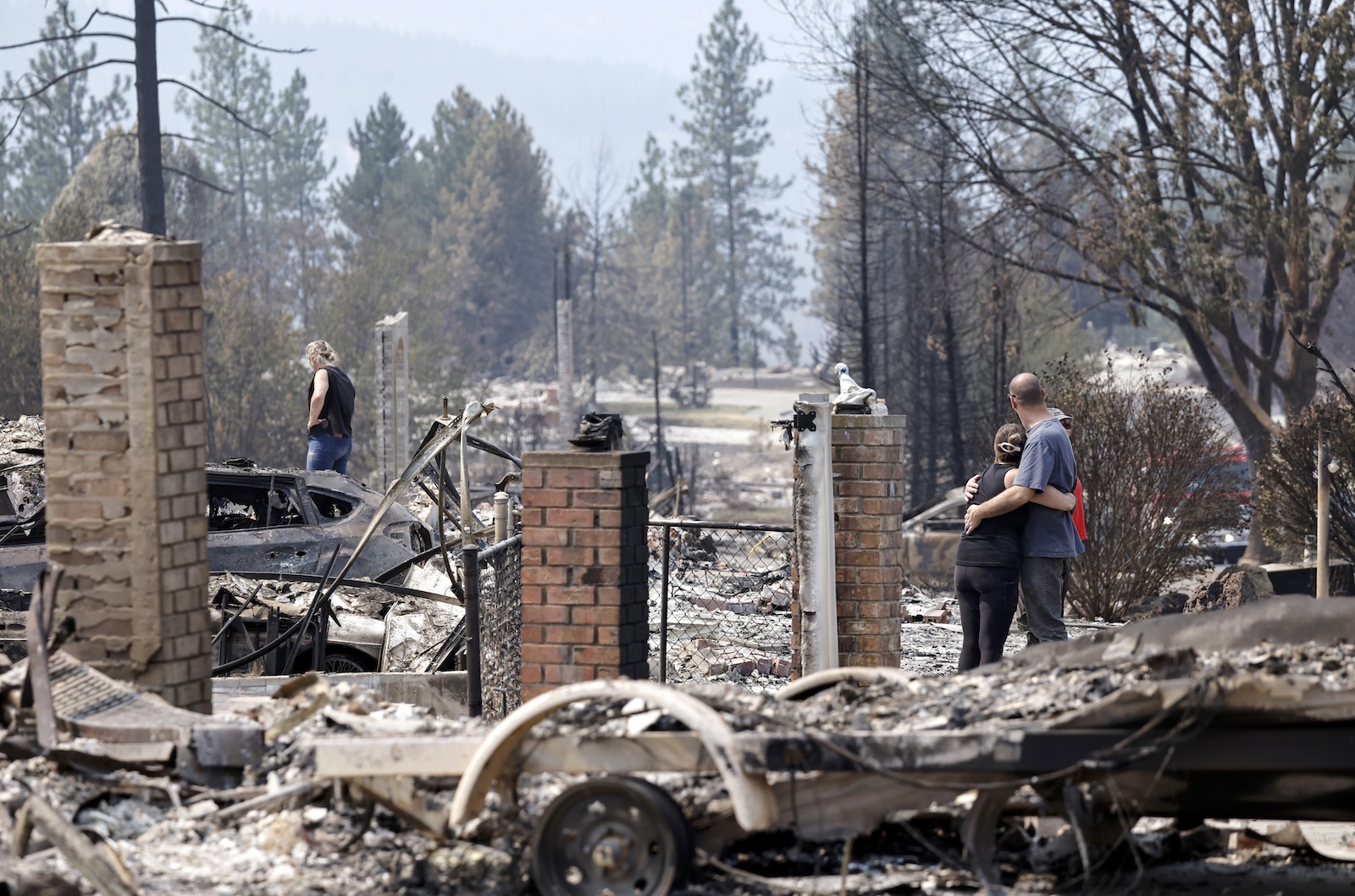 People search the wreckage after three large wildfires burned more than 900 structures in Spokane, Washington, earlier this month. Mario Tama / Getty Images