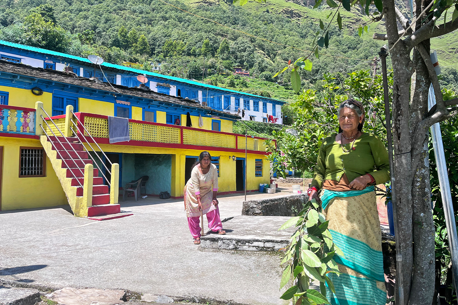 Kamla Devi, left, and Lila Devi with the tools they use to beat back forest fires. Image by Swati Thapa for Mongabay.