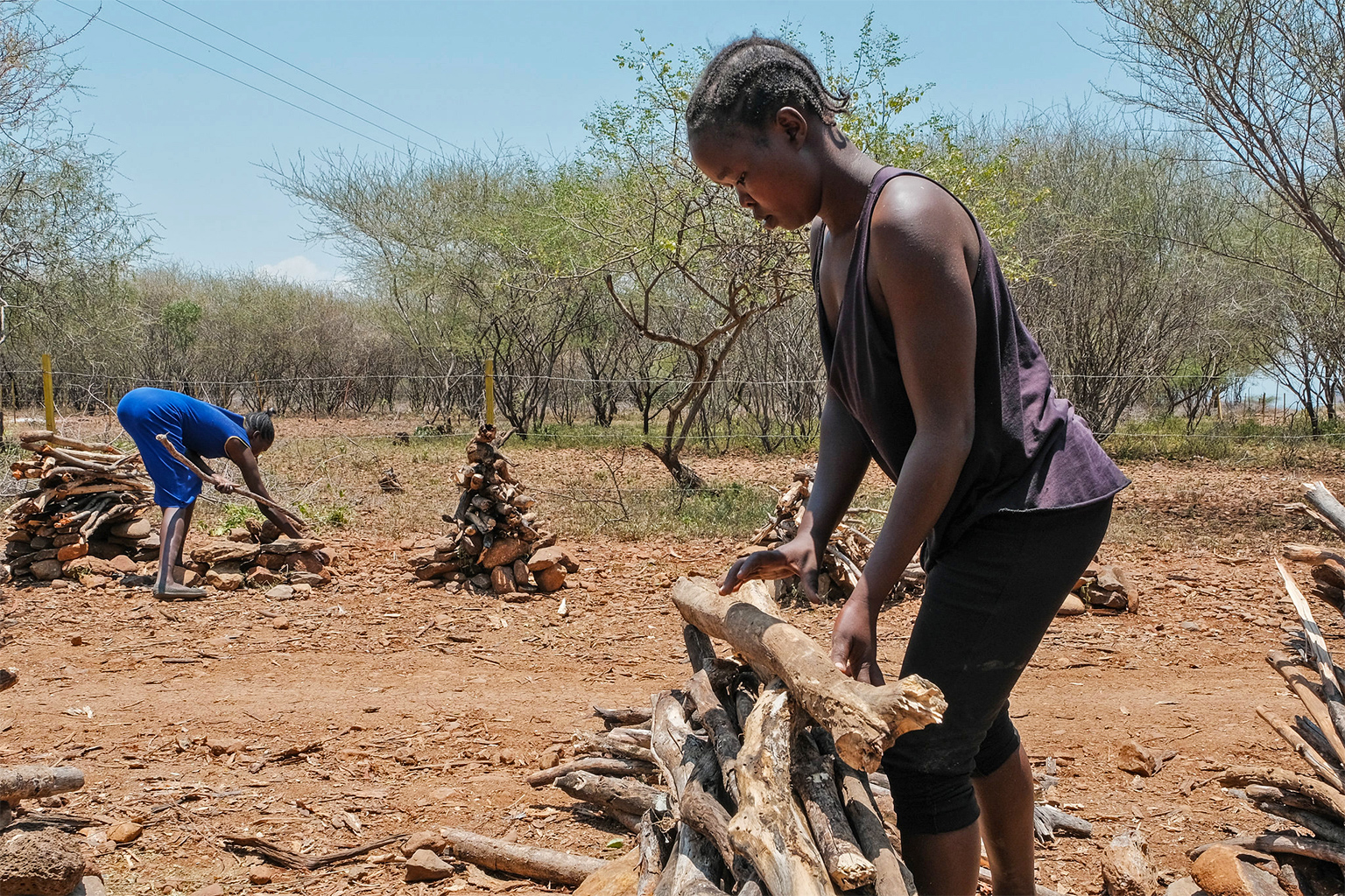 Women collect and stack firewood to sell on the roadside in Baringo county. — Image by Axel Fassio/CIFOR via Flickr (CC BY-NC-ND 2.0).
