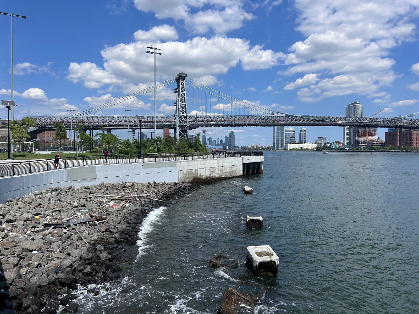 The new bulkhead at the rebuilt East River Park in Manhattan, with the Williamsburg Bridge in the background. New York City has been working to elevate the waterfront park since Superstorm Sandy flooded thousands of homes on the Lower East Side in 2012.