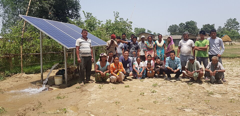Farmers surrounding a solar water pump..jpg