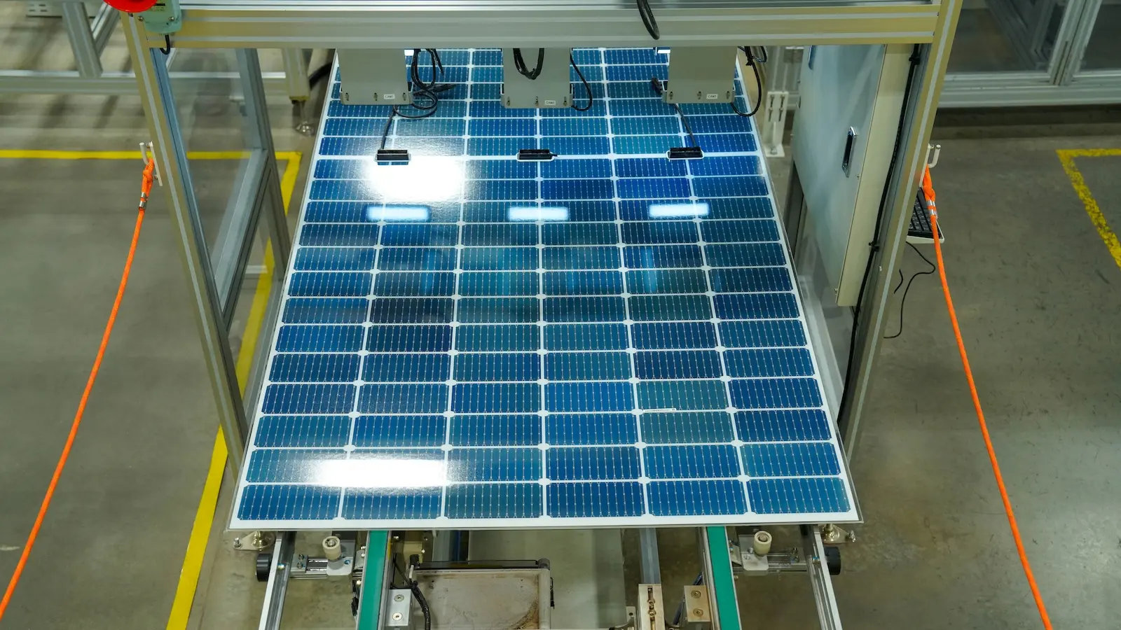 blue polysilicon wafers move down the production line on the way to making solar panels