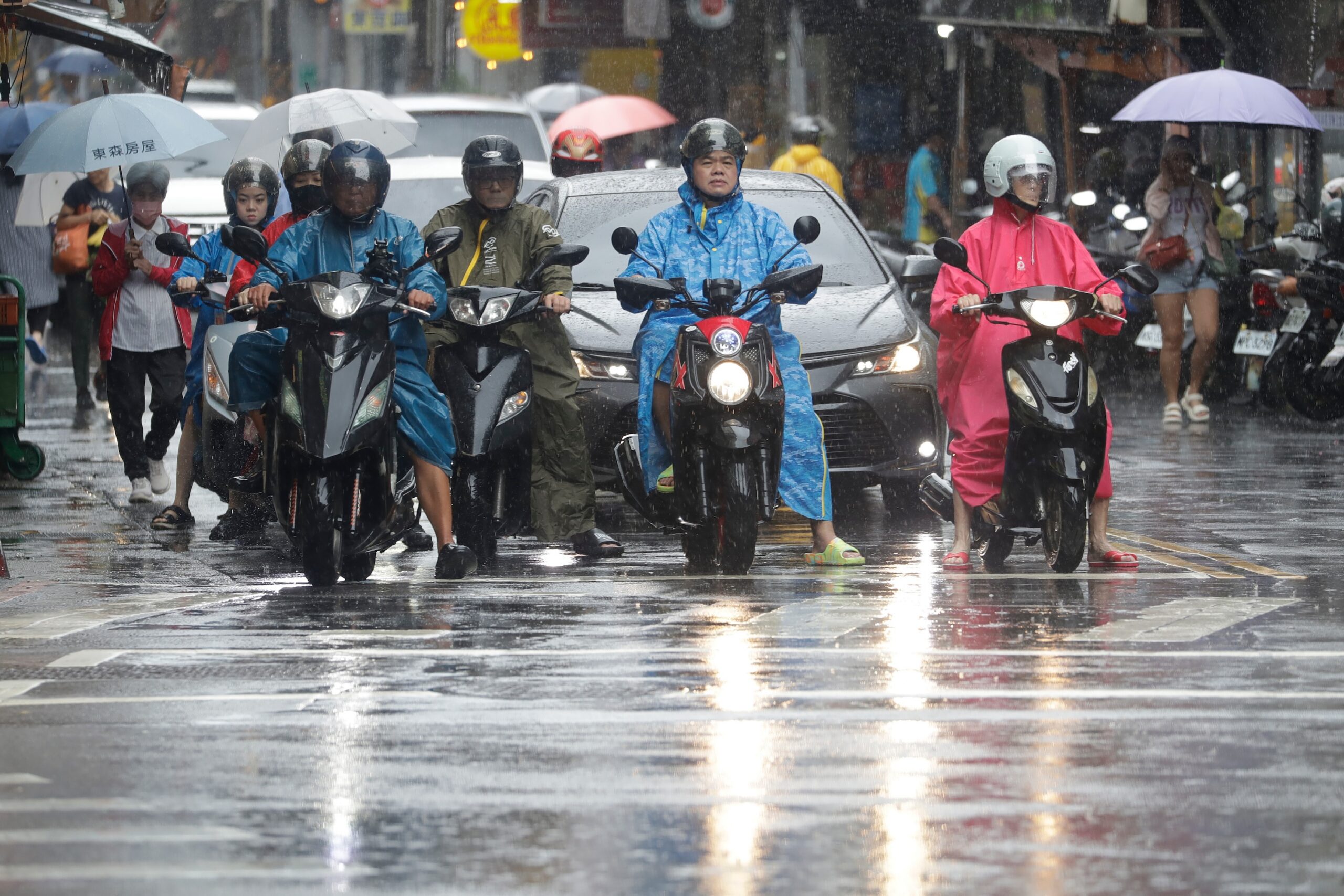 People ride scooters as Typhoon Champi approaches in Taipei, Taiwan, Friday, Oct. 23, 2026. (AP Photo/ Chiang Ying-ying)