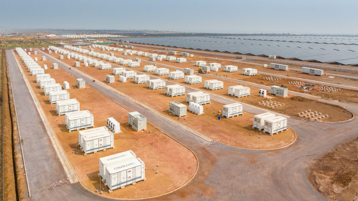 Rows of battery storage containers stand next to solar panels at the Kamoa Copper mine in the DRC — Image via Climate Home News