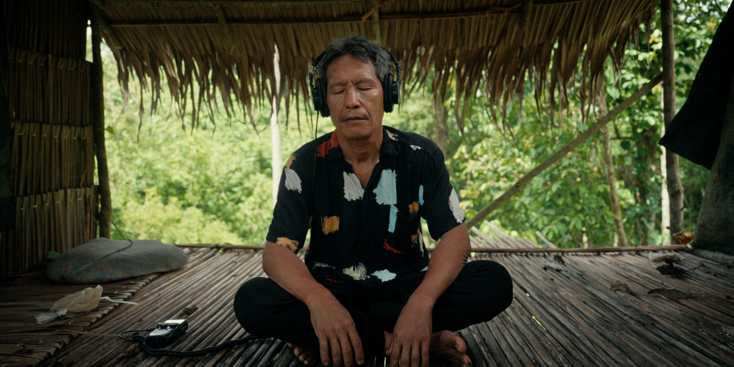 Abidin, a Balik elder, listens to forest recordings. Image courtesy of Scientific American.