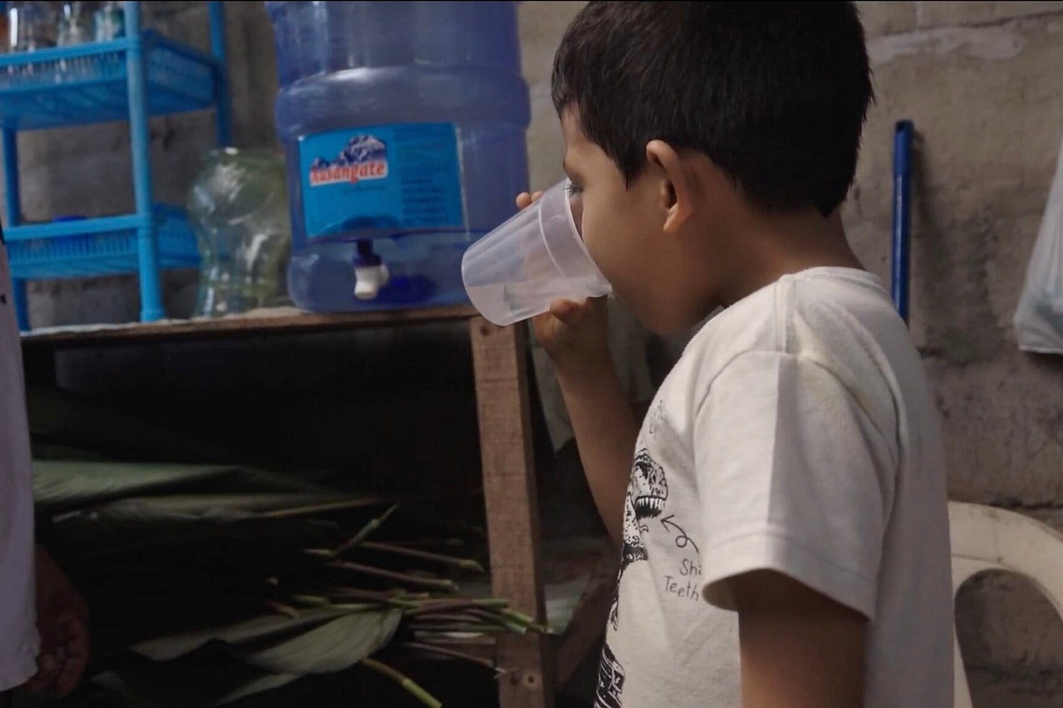 Image by Vico Méndez/Mongabay. Like most Arazaire residents, the little boy Santiago drinks water brought to the community in jerricans. The days when the Inambari was his main water source are long gone. — Image by Vico Méndez/Mongabay.