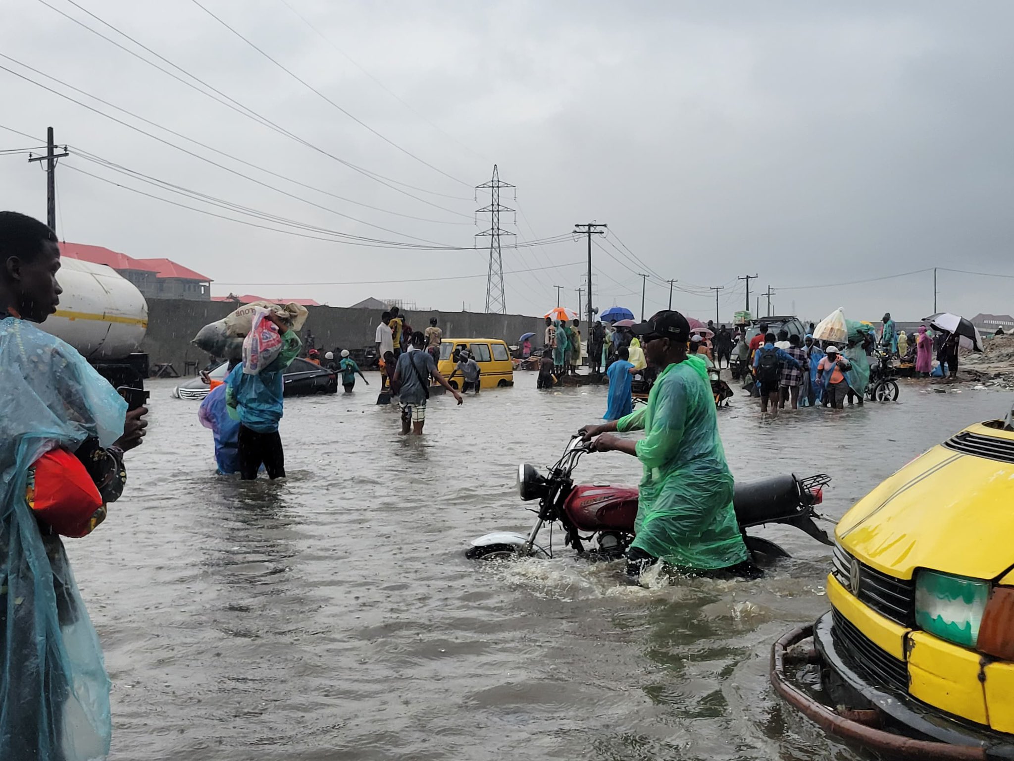 Commuters wade through heavy floodwater after a downpour in Lagos. Image courtesy of Folakemi Olaoni.