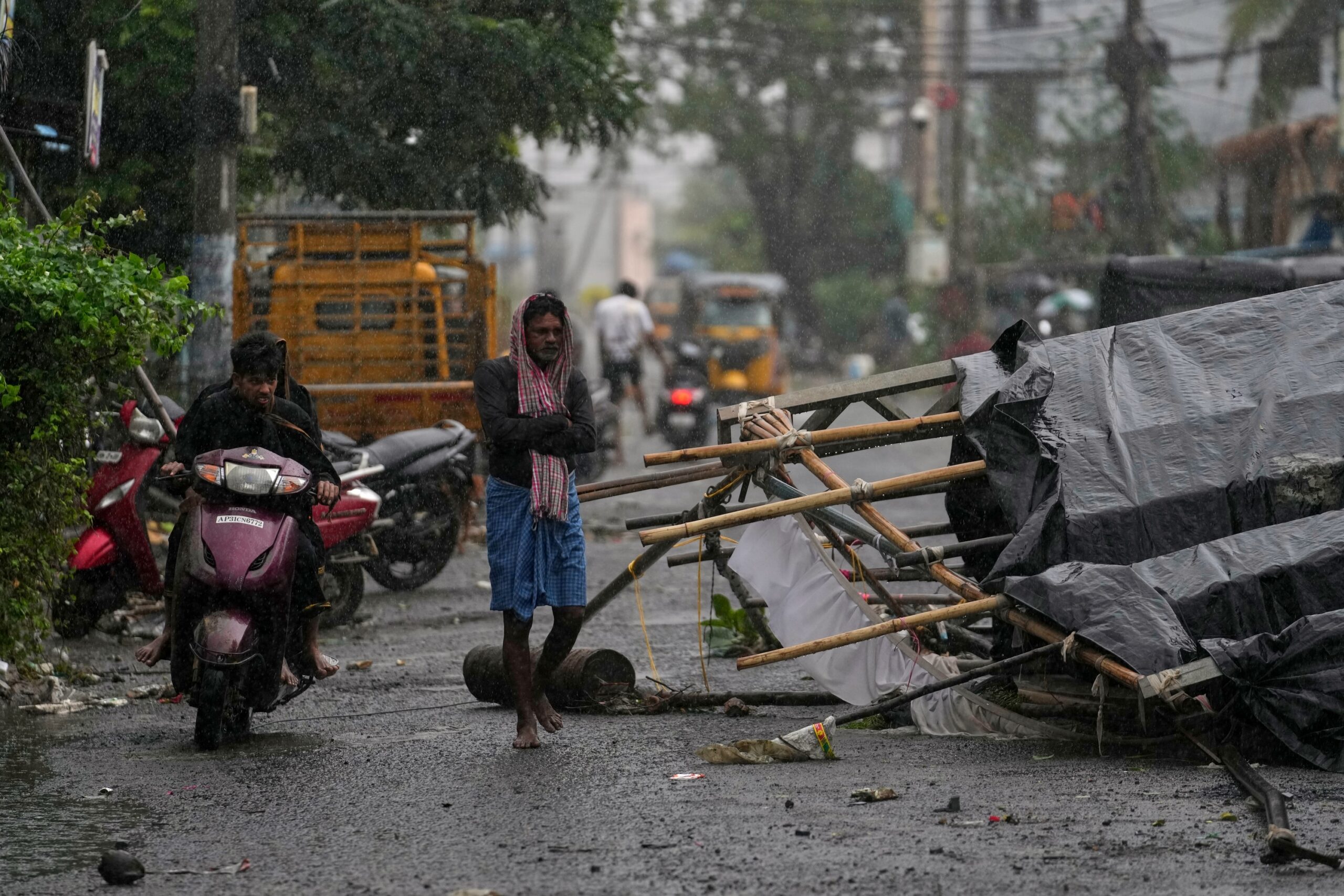 A man walks past the destruction caused at Kakinada, India, after Cyclone Arnab crossed the Andhra Pradesh coast in the early hours of Wednesday, Oct. 28, 2026. (AP Photo/Mahesh Kumar A.)