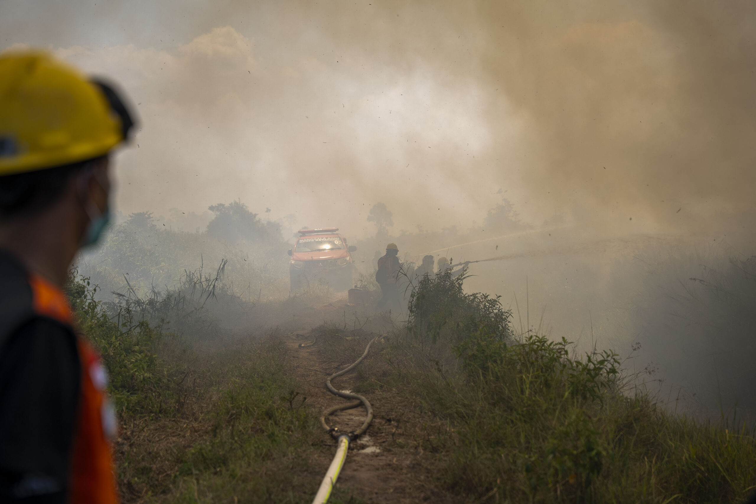 A team of firefighters trying to extinguish fire that broke out on July 22, 2026, about 1 kilometer (0.6 miles) from YIARI's orangutan rehabilitation center in Sungai Awan Kiri village, Ketapang district, West Kalimantan province. Image courtesy of YIARI.