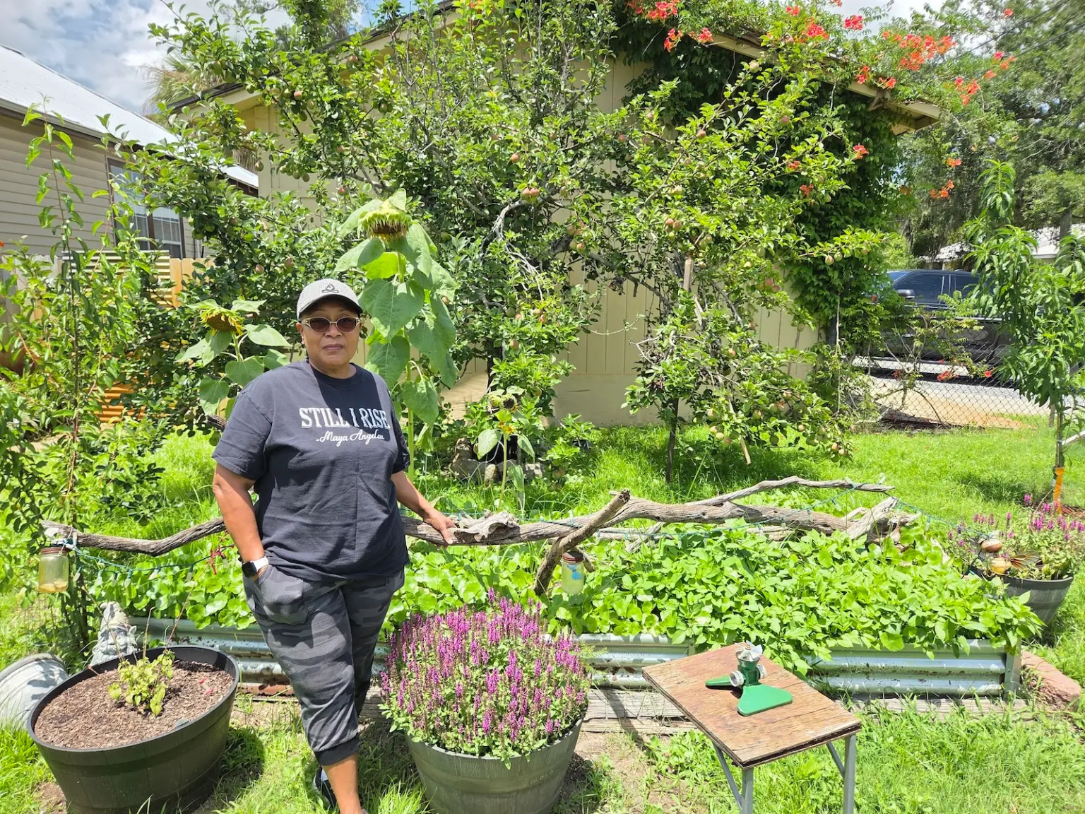 Holmes, standing in her garden, worries about pollution in the soil and water from a nearby superfund site. Emily Jones / Grist