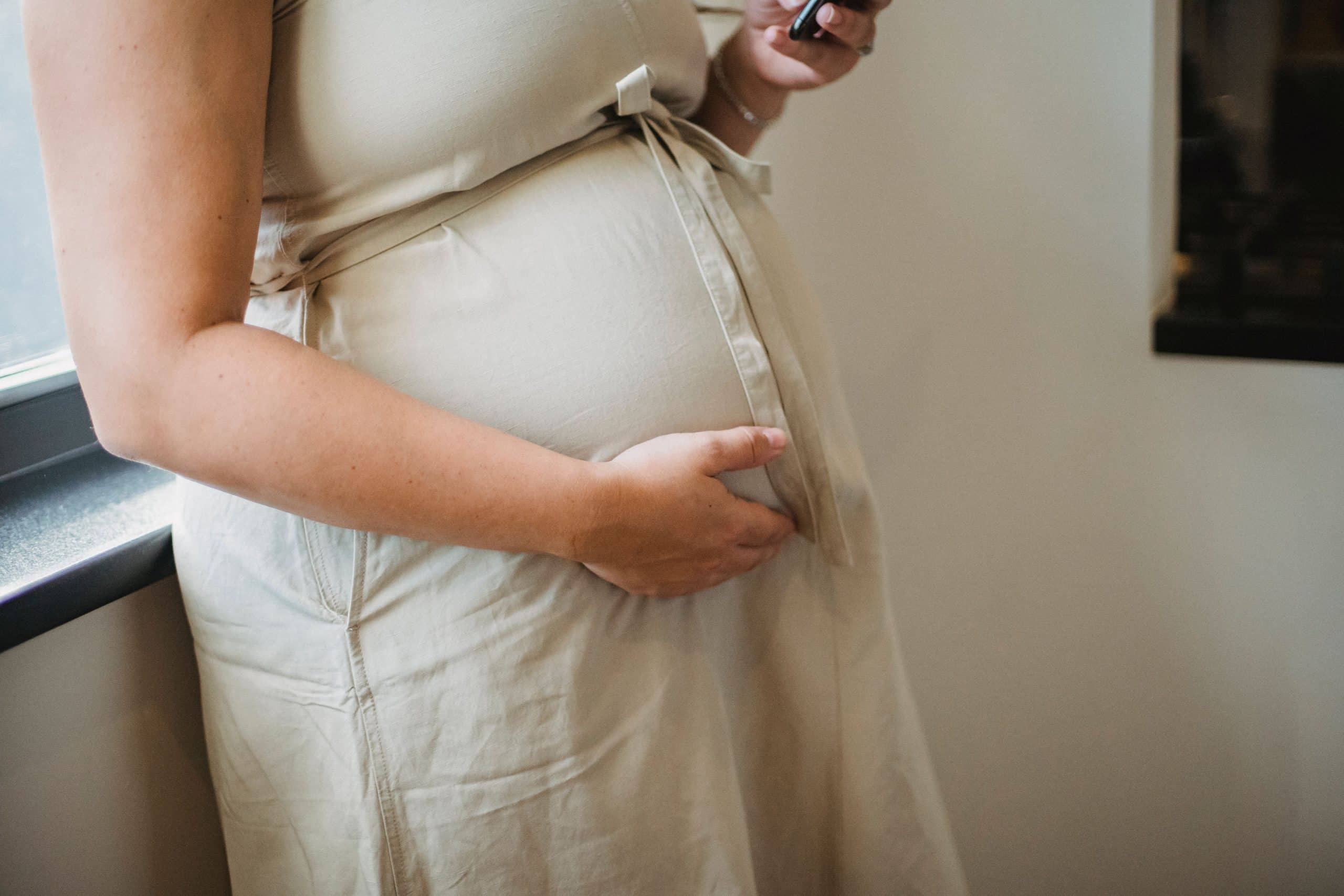 Image via Earth.org A pregnant woman holding her belly. — Image via Earth.org