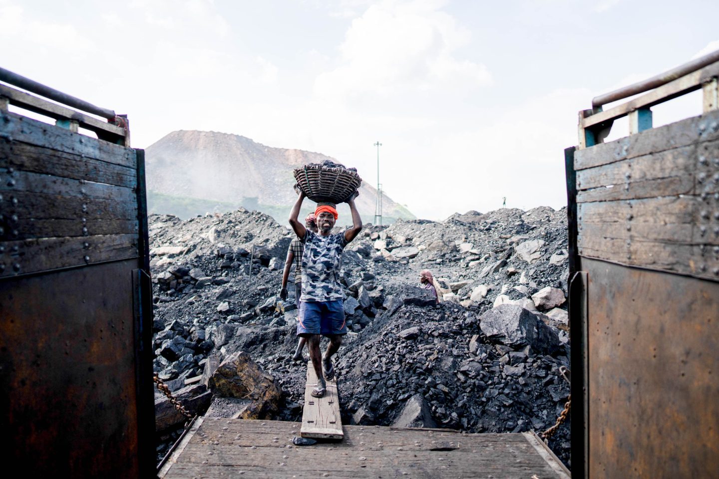 Workers load coal on a truck near an open-cast mine, on the outskirts of Dhanbad. (Amarjeet Kumar Singh / SOPA Image via Reuters Connect)